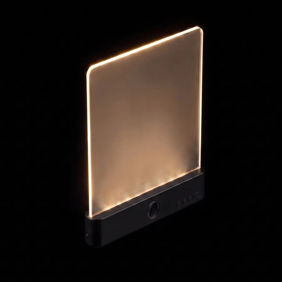 The Lorelight in black, floating on black, glowing warm